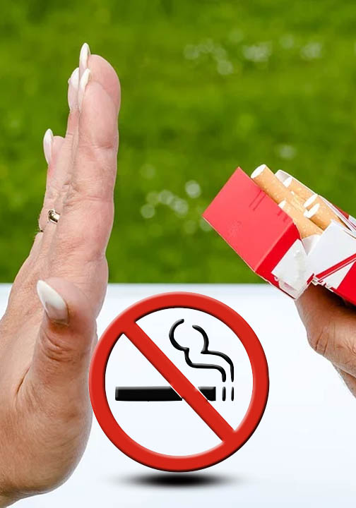 Refusing cigarettes with a stop smoking sign